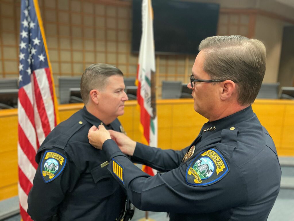 Steven Stanfield, left, is shown taking the reins of the Merced Police Department from outgoing interim chief Craig Gundlach during a ceremony at Merced City Hall on Oct. 30, 2023. Photo courtesy City of Merced